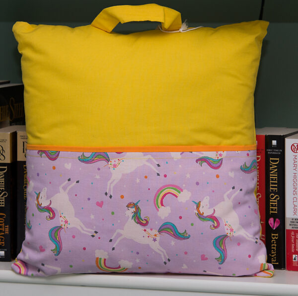 reading pillow for kids with a front pocket easy to grab when traveling to carry books, coloring books, crayons.